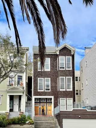 A beautiful old apartment made of shingles