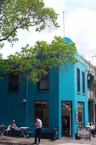 People sitting in the sun outside a coffee shop