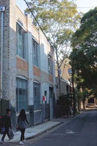 People sitting in the sun outside a coffee shop
