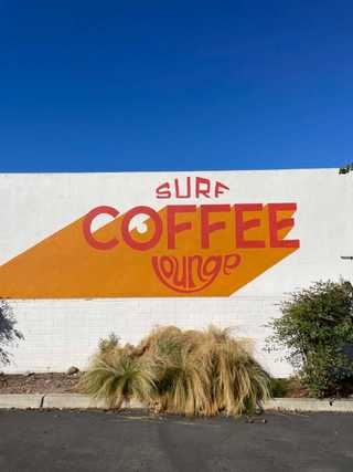 A colourful mural stating Surf Lounge at Pacific Beach