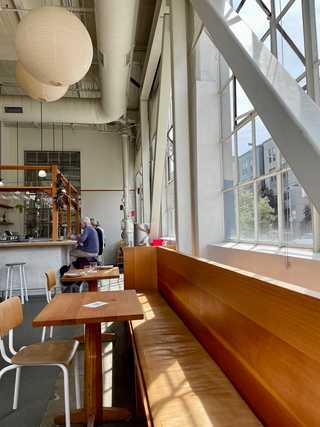 Light flooding in through big industrial windows at Tartine