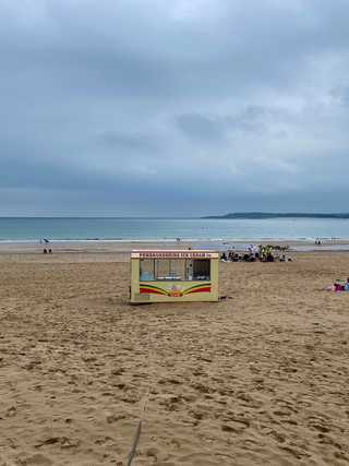 A solitary ice cream van on a quiet beach