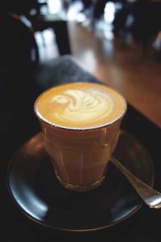 People sitting in the sun outside a coffee shop