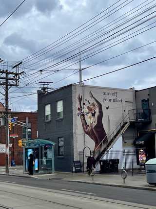A grey city scene with a grey graffiti at the background