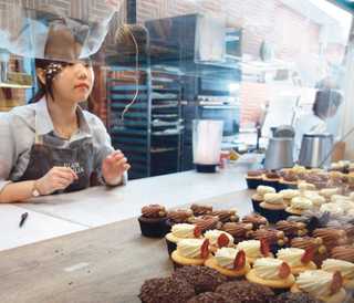 Coffee shop counter shows a collection of cakes